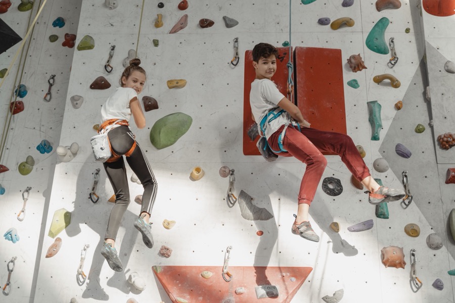 Kids on an indoor climbing wall