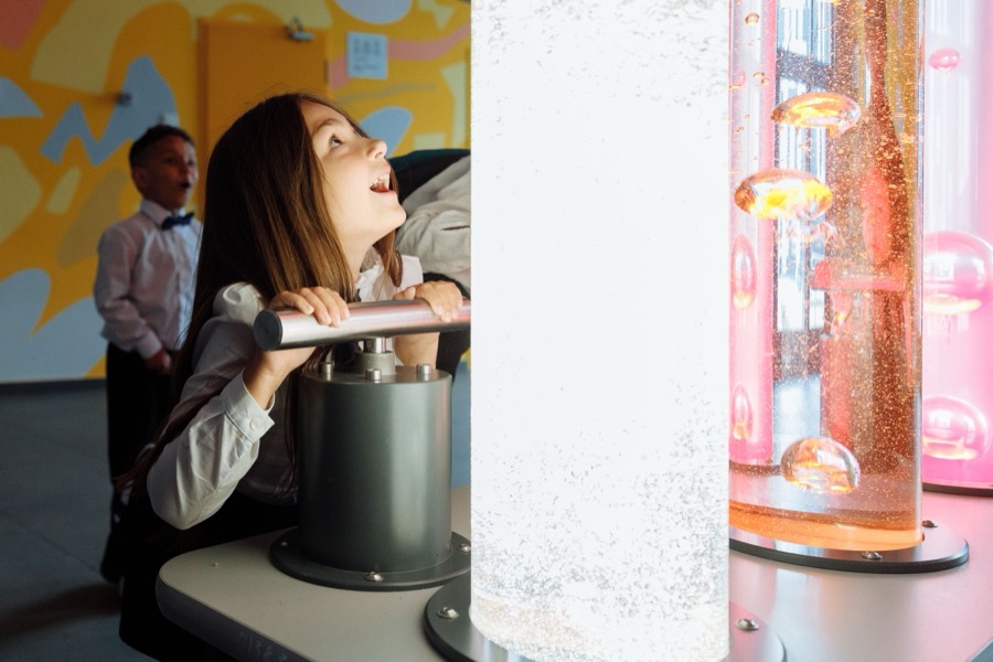 Child at an interactive science museum exhibit